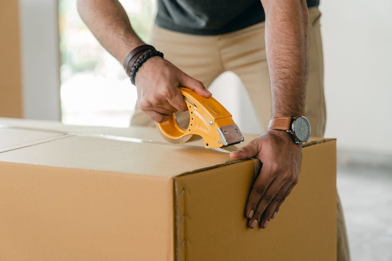 Family moving cardboard boxes into a new home